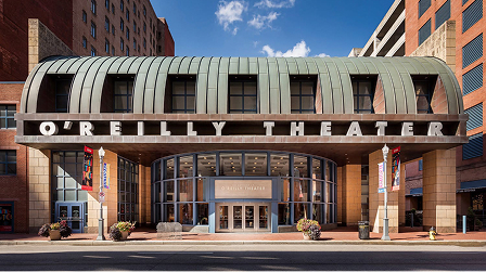 Exterior of the O'Reilly Theater with its curved metal marquee and glass entrance.